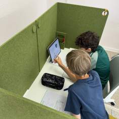 Zwei Schüler nutzen dadoEASY Arbeitsplatztrennung in Grün für gemeinsames Lernen