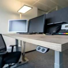 Höhenverstellbarer Schreibtisch im Büro der PFISTERER AG mit elektrischer Bedieneinheit