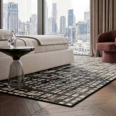 Object Carpet Rebell Teppich in einem Wohnbereich mit urbanem, rasterartigem Muster